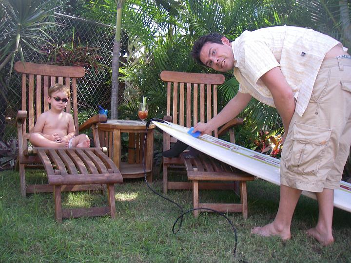 IMGP5608.JPG - Doug is getting his board ready for another outing to the beach...well, this is my board that he bought me for Christmas last year. Too cool that it was here for him to ride!