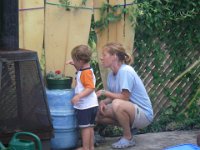 IMGP3753  Talking to his little baby cactus in the cactus garden. Sammy helps me with the garden by watering and telling me which plants need "snacks" - some Miracle Grow feeding sticks. He likes to feed the plants :) Note the fence - Dave did a great job later in the week creating a privacy screen in this area.