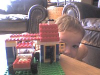 ATT01422  We got him some of his very own Legos to play with. He LOVED playing with Legos on our trip, so it was time to give him some. He now has his own collection going. I totally love building with them, too! Here's my dream home, complete with carport and Jeep :)