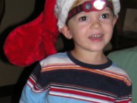 2007-12-18CarolingHawaiiStyle (8)  Christmas caroling at a friend's house - Sammy has a stocking hat and we're the only ones with a headlamp :) He loves wearing it!