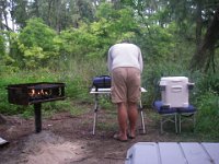 IMGP6316  Here is my dear husband working hard every meal to feed us wonderful camping fare. I think French press coffee is the first order of the day, shown here lighting the burner.