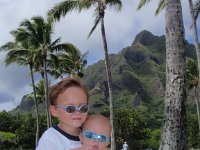 PA160009  We stopped off at Kualoa Beach Park for a quick romp afterwards. Sam held Ben while I cleaned up the sand toys. Cute backdrop for a photo I quickly realized! Plus, they were being sweet! Whoa!