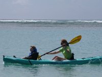 2008-11-10SUP AlaMoanaBeachPark (8)  We are in the process of switching out gear to accommodate growing family and kids. Dave researched kayaks and purchased this one from the nicest guy in the world - he owns Go Bananas in Honolulu and is an expert kayaker. He's taken his three kids out since they were babies. This is a fishing kayak from New Zealand, and it is perfect for an adult and big kid up front. The front space is for fishing gear, but this rig doesn't have a hatch, so it is a better seat for Sam. They customized it with a seat rest and bought him his own paddle! You'll see him in action later I think.