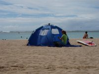 PB090136  Setting up the beach tent and changing a diaper.