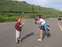 PC160016  Soooo...I billed this hike as an escape from the muddy mountains. Let's go somewhere makai, says I, to hopefully find a trail that's dry! Gramma and Sam are doing a little sword-fighting to pass the time while we gear up. (Trekking poles for swords.)