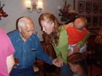 2009-01-04Honey'sGailBillAlliRich (3)  At an informal concert each Sunday at mom's church - amazing local musicians play and jam together. This is Eddie Kamae...Sam got to have his picture taken with him, so now we're signing a CD!