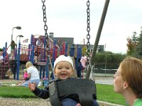 9-21-2005SwingInPark (7)  Here is little 9 month old Sam! Now we're back at the same playground and he can't get enough of the merry-go-round, running and running and spinning whomever can hang on tight enough.