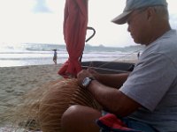 IMAG0338  Making a basket using a float as a shape. Found him on my beach jog. He does computer programming for his day job, and was just out early in the morning finishing this up before work.