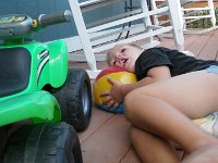 IMGP3200  I came outside to find Ben working on his ATV with a little pillow for his head (his blow-up ball).