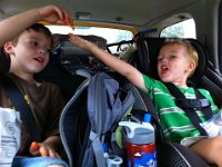 passing cheeto  Oh boy. Another naughty mommy treat. After a busy day hitting playground then commissary after school, thought they should get to have some Cheetos and Cheezits. After all, Ben's friend Camden gets to eat Cheezits for a lunch meal while out on the trail! It is a full blown food group - did you know that? Ben is getting a Cheeto from Sam.