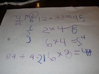 IMGP4427  Some placemat math while waiting for dinner. Sam nailed the 84/4 before Dad was even done writing the equation!