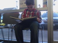 IMAG1306  Waiting for haircuts - Sam is reading about the Brooklyn Bridge. This is reading level 8+. Such a great guy. We were all so absorbed in the story.