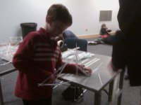 IMAG1367  Now building a big cantilever to hold up 100g weight. The longest one out from the table won the informal contest. Sam and Dad tied for first!