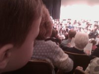 IMAG1434  In the symphony now. Ben leaned waaaay down at one point and took a look at the lady in front of us. She turned and looked at him very quizzically. I thought it was funny and so did he - a big broad smile at her. It wasn't returned much :)