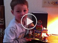 Ben talking about his ice cream stand  One of many movies Gramma and I took over the holiday to give you a flavor of being here. This is about a cute little lighted ice cream stand that Benji got at ACE when he was with Gramma. He LOVES looking at these little village homes, and this year he finally got one of his own!