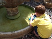 2013-04-01 (87)  Richard has a fountain that Ben loves to play in. Each time we visit we get him a little boat to drive around in the fountain. He talks to the characters and makes them jump off the "high dive."