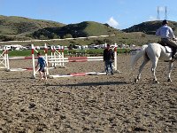 2013-04-01 (90)  There's Sam after helping Mickey. The rider is Lane Clarke. He is known for Grand Prix wins, jumping over 7' jumps. The horse he is riding is worth $80,000. He is schooling it for the owner who will show it over the weekend. The Grand Prix horses are worth $500,000-$1,000,000. This is a totally different horse world than I grew up in. Today, many horses actually have ear plugs in so they are not distracted!