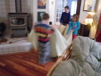 IMGP0239  They thought it was hilarious! Put Windex on the bottom of a sheet and your floors clean right up. Plus if you have the kids pull, they tire out.