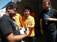 IMGP9605  The NASA-funded team from Arizona State Univ (whose robot had some unfortunate psychological troubles - it was hearing commands that were not being given to it by the driver - some kind of interference). Poor guys - I tried to cheer them up a bit - they certainly had a good story to tell about the weird issue their bot had! They are holding a panda given to them by the Chinese team, in orange.