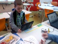 Pic-02052014-003  Ben at robotics club, filming a 4th grader working on an experiment. He seems to fit right in. I volunteer to help out with the club, so Ben comes along as well.
