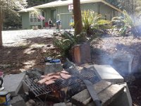 20140402 131229  Spring Break fun! I'm cooking SPAM up on the fire while the boys shoot hoops and run around in the woods with their friends.