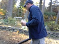 20141115 141219  Dave out blowing leaves with a Duvel in hand.