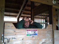 20141127 123719  Steve (Emmy's owner) taking a call while trying to keep Jack (big German shepherd) contained in a stall. This is Steve's preferred "office." :)