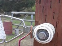 20150318 140825  Do you think that red section is hot? I'm told it's insulated enough I wouldn't feel a shock, but I have to say I am careful each time I thread a chain through that space between wire and wood to close a gate!