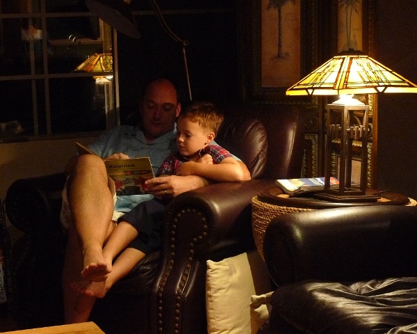 2010-04-04easterdinnerlamb-9 Daddy still feeling pretty sick, but reading Sam one of his favorite books.