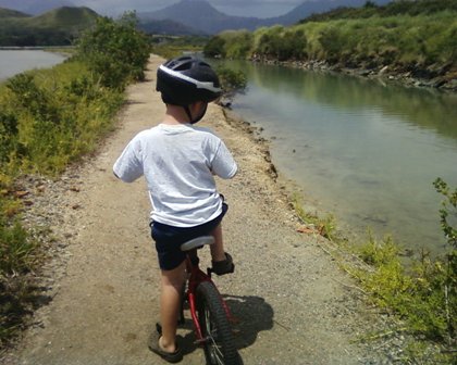 att01084 Sam biking around the fish ponds while I run with Ben.