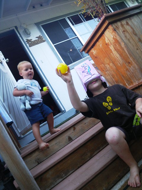 Boys after dinner playing funny games with their new toys. Reduse, reuse, recycle!