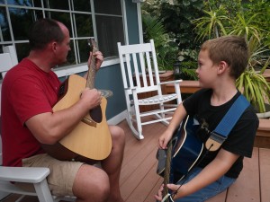 Sam and Dave jamming  - click for video. Dave just started taking some guitar lessons - his first I think. Before that his Dad was showing him the ropes many years ago. We have a picture of Bill playing for Dave when Dave was about this age. Hey Pop Pop - when you come out, bring your guitar?