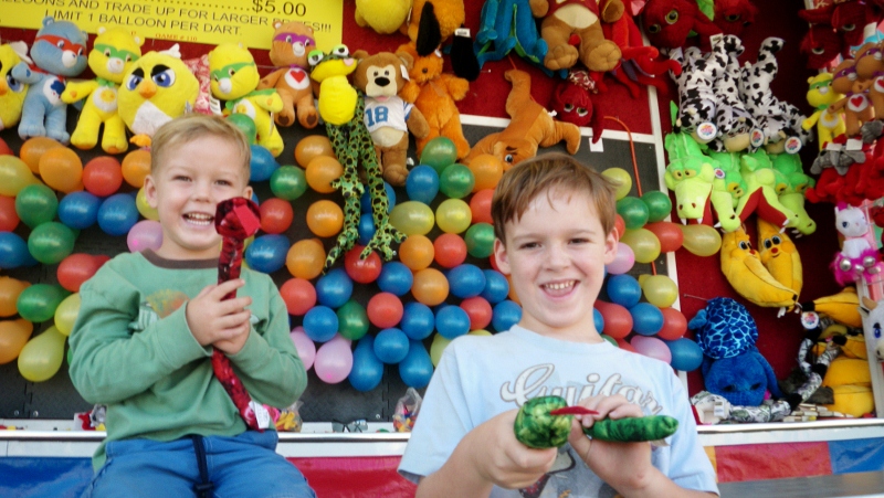 The kids winning their snakes at a carnival at the Kitsap County Fair!