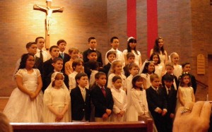 Afterwards - Sam is in back left. 14 boys and 3 girls in his PREP class. The rest of the children pictured here are from St. Cecilia Catholic School, the parish school.