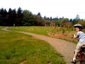 Out for a morning mountain bike ride (boys on bikes, mommy racing alongside to help Ben brake!). Could see mountains over the distant tree line. So pretty. Picture doesn't do it justice. Boys going very fast - got few pictures. 