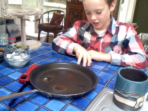 Melting sugar - well, carmelizing it - to see what happens. It's edible chemistry! I hope we can clean the pan!!!